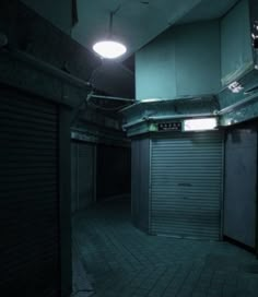 an empty storage room with closed doors and a light hanging from the ceiling above it