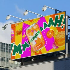 a large advertisement on the side of a building in front of a tall building with lights