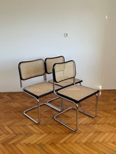 two chairs sitting on top of a wooden floor