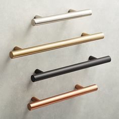 four different types of handles on the wall, one black and one gold are shown