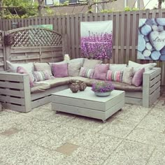 a couch made out of wooden pallets sitting on top of a patio