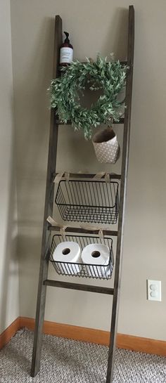 an old ladder is used as a shelf for toilet paper