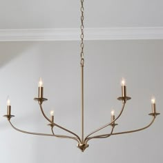 a chandelier with six lights hanging from it's center and four arms