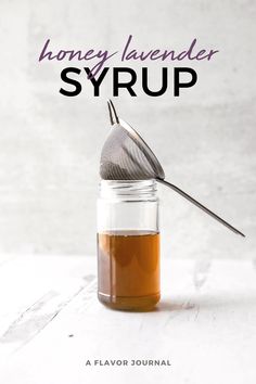 honey lavender syrup in a glass jar with a metal strainer on the top and text overlay that reads honey lavender syrup