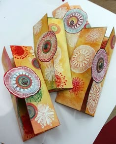 four pieces of paper with designs on them