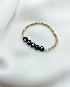 Choose a name, place, team, word or initial. Make it your own and wear your heart on your wrist! 3mm Gold Filled or Sterling Silver beads used with white letters on black beads. Choose your size for a custom bracelet made just for you! Circle letter bracelets look best with a short phrase or name. If you have a longer name or phrase you would like, please check out our “Dainty Name Bracelet” that use smaller square beads that accommodate longer names/phrases better. If you would like initials/sh Inspirational Personalized Faith Name Bracelet, Gift Black Name Bracelet With Custom Text, Customized Black Jewelry For Everyday, Inspirational Black Bracelets For Everyday, Customized Black Beaded Bracelets, Customized Black Beaded Bracelets For Everyday, Black Jewelry With Custom Text For Personalized Gift, Personalized Black Jewelry With Custom Text, Personalized Inspirational Black Bracelets