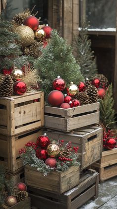 Wooden crates filled with Christmas decor, including trees, ornaments, and pine cones, create a rustic outdoor holiday Christmas Porch Crate Decor, Christmas Decor With Crates, Primative Christmas Decor Country, Rustic Christmas Trees Ideas, Rustic Christmas Home Decor, Vintage Red And Green Christmas Decor, Christmas Barn Decorations, Rustic Outdoor Christmas Decorations, Wooden Crate Ideas Home Decor