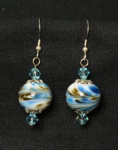 earrings with blue and white swirls on them