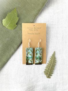 Title: Oregon Coast Looking for a unique handmade addition to your jewelry box? This pair of lovingly hand-painted wooden earrings will add artistic flair to your wardrobe or a personal touch to your gift to a loved one.  These original handcrafted earrings are hand painted on balsa wood with sterling silver hooks for sensitive ears (the gold hooks are gold plated sterling silver). Each pair of earrings in my shop is carved and painted by hand, and the item you receive is the exact one seen in the photos. The earrings are lightweight and hypoallergenic. This gift can be personalized with a special note and sent directly to friend or loved one. Please add the note during checkout using the box Etsy provides for "Notes to Seller." Looking for a different design? Check out my shop to find oth Hand Painted Artsy Earrings For Everyday, Adjustable Hand Painted Nature-inspired Jewelry, Whimsical Green Hand Painted Earrings, Green Hand Painted Artistic Earrings, Hand Painted Earrings Wood, Nature-inspired Hand Painted Drop Earrings, Coastal Jewelry, Hand Painted Earrings, Painted Earrings