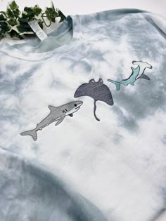 a t - shirt with an image of two sharks on it