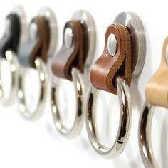 a row of metal rings mounted to the side of a wall