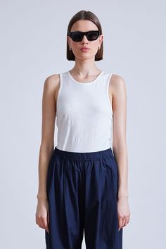 100% Cotton Made in India Sleeveless, crew neck, scooped armholes, can be worn tucked in or out Machine wash cold on gentle cycle with like colors, lay flat to air dry Fits true to size. Select your usual size Model is 5'10" and wearing a size small Air Dry, The Label, Lay Flat, The Modern, The Selection, Crew Neck, India, Cream, How To Wear