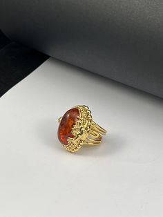 Handmade ring made entirely by hand with figures of Puttini in gilded silver Romantic style with a Baltic Amber cabochon in the center Adjustable one-piece size Dimensions Cm 3,x3,2 Inches 1.38x1.26 The item shipped will be that of the photo because it is a UNIQUE PIECE. A handmade jewel is unique and unrepeatable: it could be reproduced or proposed in other variations, but it will never be identical to another piece Produced in my workshop in the heart of Tuscany, the item is shipped from FLORE Handmade 14k Gold Oval Cabochon Jewelry, Gold Oval Cabochon Jewelry Gift, Gold Oval Cabochon Jewelry As A Gift, Gold Heirloom Signet Ring With Cabochon, Formal Gold Cabochon Signet Ring, Heirloom Gold Signet Ring With Cabochon, Hallmarked Amber Oval Cabochon Jewelry, Elegant Amber Cabochon Ring, Amber Oval Cabochon Jewelry For Gifts