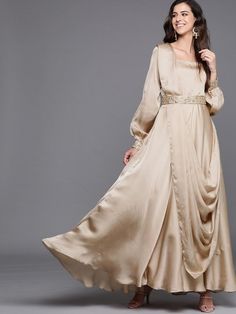 Buy smashing beige solid flared gown with attached dupatta and embroidered belt online at best price. This mind-blowing style kurta goes perfectly for upcoming festive and grand events. Dupatta Attached Gown, Traditional Drape Maxi Dress For Eid Party, Bollywood Style Cream Floor-length Gown, Evening Eid Anarkali Set Maxi Length, Gold Maxi Length Gown For Eid, Bollywood Style Cream Floor-length Dress, Gold Maxi Gown For Eid, Cream Floor-length Bollywood Dress, Cream Bollywood Floor-length Dress