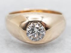 a gold ring with a diamond in the center