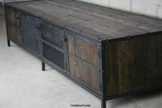 a large wooden table with metal accents on top