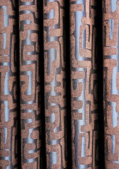 the curtain is made up of brown and blue fabric with an abstract design on it