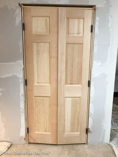 two wooden doors sitting in the corner of a room