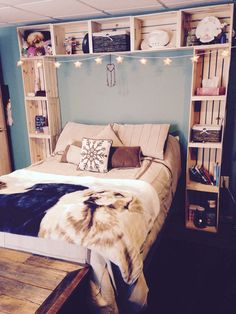 a bed sitting in a bedroom next to a book shelf filled with lots of books