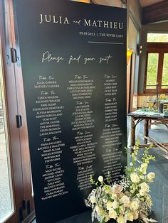 the seating chart for julia and mathieu's wedding is displayed on a blackboard