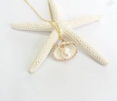 Beautiful gold sea shell necklace made with a gold plated seashell charm with a gold filled chain and fresh water pearl. This necklace makes a unique gift for a beach lover or someone special in your life. The seashell is around 15- 20mm long. Each item is carefully packaged in a beautiful jewellery box ready as a gift. If you would like to add a personalized note with your order, just write a note at checkout and I will send a small card with your gift to the recipient. Please choose necklace l Handmade Gold Shell Pearl Necklace, Gold Shell-shaped Pearl Necklace, Gold Shell Necklace With Pearl Pendant As Gift, Gold Pearl Necklace As Gift, Gold Ocean-inspired Charm Necklace For Gift, Ocean-inspired Gold Charm Necklace For Gift, Gold Ocean-inspired Charm Necklaces As Gift, Strand Shell Necklace With Pearl Charm As Gift, Gold Shell With Pearl Charm As Gift