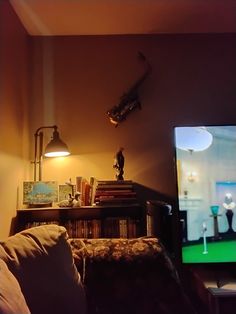 a living room with a couch, lamp and television in front of the tv screen