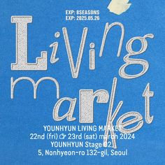 an advertisement for the living market on a blue t - shirt with white lettering and a bird flying over it