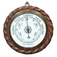 an old fashioned barometer with the word rain change on it