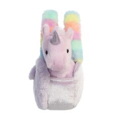 a small stuffed animal with a unicorn horn on it's head sitting in a bag