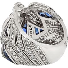 Immerse yourself in the world of luxury, where artistry and innovation converge in the Cartier 18K White Gold Diamond And Sapphire Dove Ring. This exquisite piece embodies elegance and grace, featuring a stunning dove motif crafted from 18K white gold, adorned with shimmering diamonds and vibrant sapphires. The intricate design captures the essence of love and freedom, making it a perfect symbol for cherished moments.Crafted by renowned designer Cartier, this ring is a testament to timeless beauty and exceptional craftsmanship. The diamonds and sapphires sparkle with every movement, creating a mesmerizing display of light and color. Whether worn as a statement piece or as a symbol of affection, this ring is sure to captivate hearts and turn heads wherever you go.Indulge in sophistication a Elegant Cartier Diamond Ring With Brilliant Cut, Luxury Cartier White Gold Diamond Ring, Luxury Cartier Rings For Formal Occasions, Luxury Sapphire Diamond Ring With 17 Jewels, Luxury Sapphire Cluster Ring, Luxury Diamond Ring With Pave Setting, Luxury Sapphire Birthstone Ring, Cartier Luxury White Gold Diamond Ring, Formal Luxury Cartier Diamond Ring