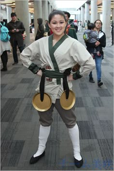 a woman dressed in traditional japanese clothing poses for the camera with her hands on her hips