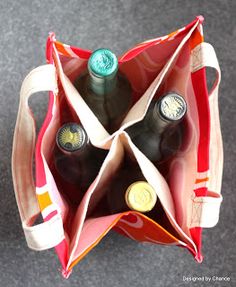 two bottles of wine are in an open bag