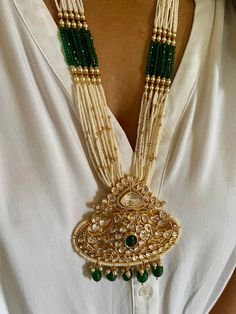 All our pieces are in stock and will be dispatched within 24 to 48 hours of order. Orders received during the weekend will be dispatched on Monday. The white and green beads strings on both sides of an elegant Kundan pendant make it a statement wedding necklace. One of our favorite picks for the wedding season ❤️ Dimensions Weight of the necklace: 78 grams Drop Length of the necklace: 12 inches Height of pendant: 3.5 inches Width of pendant: 3 inches Weight of earrings is 46 g per pair. Length o Fusion Style Temple Necklace Pendant For Wedding, Fusion Style Pendant Temple Necklace For Wedding, Fusion Style Jeweled Bridal Necklace For Celebrations, Ornate Green Jewelry For Festivals, Kundan Pendant Necklace With Intricate Design For Wedding, Kundan Wedding Necklace With Intricate Pendant Design, Wedding Kundan Pendant Necklace With Intricate Design, Green Necklace With Intricate Design For Wedding, Temple Jewelry Pendant For Wedding