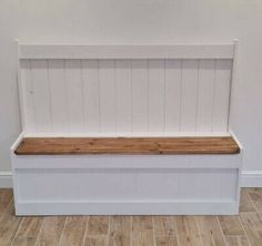 a white bench with wooden seat on the floor