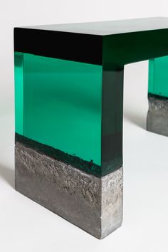 a green and black table sitting on top of a white floor