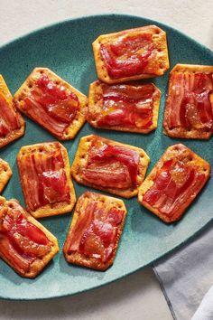 small pieces of toast with bacon on them