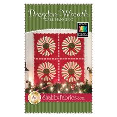 a red and white quilted christmas tree skirt