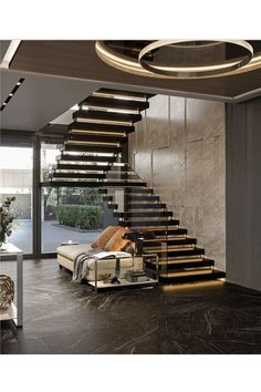 a living room filled with furniture next to a stair case