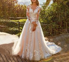 a woman in a wedding dress standing on a deck