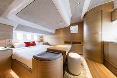 a bed sitting inside of a bedroom on top of a wooden floor next to a window