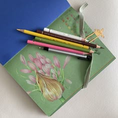 four pencils are sitting on top of a card