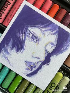 an image of a woman's face painted in watercolor on paper with crayons