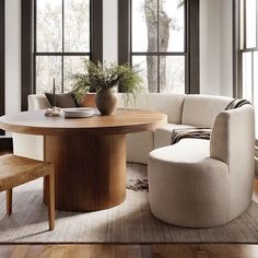 a living room with large windows and a round table