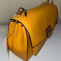 Beautiful Leather Bag With A Bright Orange Color . Brand New With Tags! Elegant Yellow Bag With Branded Hardware, Elegant Yellow Bags With Branded Hardware, Modern Yellow Bags With Gold-tone Hardware, Trendy Formal Shoulder Bag With Branded Hardware, Classic Yellow Office Bag, Chic Yellow Office Bag, Yellow Leather Shoulder Bag With Branded Hardware, Trendy Michael Kors Bags With Gold-tone Hardware, Trendy Michael Kors Leather Shoulder Bag