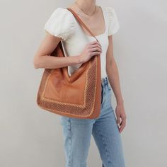 Channel your boho side with the Daisy Hobo. It's all in the details. This super soft leather paired with beautiful crochet is '70s-inspired perfection. Details: 15" W X 16" H X 3" D Unlined N/A Fits your phone and small tablet N/A Hidden Magnet Closure 11.5" Strap Drop Solid leather single strap Bohemian Light Brown Tote Shoulder Bag, Bohemian Shoulder Bag With Braided Handles For Shopping, Brown Woven Leather Hobo Bag, Rectangular Brown Woven Leather Hobo Bag, Brown Woven Leather Rectangular Hobo Bag, Brown Woven Leather Hobo Bag For Shopping, Cognac Woven Leather Bag, Bohemian Shoulder Bag For Fall, Brown Bohemian Shoulder Bag For Shopping