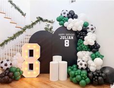 a birthday decoration with balloons and soccer balls