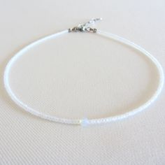 Moonstone beaded necklace, White seed bead choker, Waterproof necklace, Tiny simple choker, Stainless steel jewelry There are two clasp options: stainless steel clasp and chain, the clasp and chain are made of brass with 14k gold plating, so the necklace will not lose its look over time! Measure the length of your neck with a measuring tape, or you can use any string, rope, or phone cable, and afterward plot the measurements on a regular ruler. The length of the choker is 12 inches with an adjus Minimalist Tiny Beads Choker As Gift, Minimalist Tiny Beads Choker For Gift, Simple Adjustable Choker As Gift, Dainty Adjustable Single Strand Choker, Minimalist Handmade White Crystal Necklace, Adjustable White Choker For Everyday Wear, Everyday Adjustable White Choker, Minimalist Gemstone Beads Choker As Gift, Minimalist Gemstone Beads Choker Gift