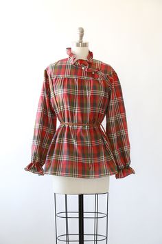 "Vintage 1970s Fall plaid blouse High neck ruffle neck + puff ruffle sleeves Great vintage condition M e a s u r e m e n t s: Size: fits like a M L BUST: 23\" Waist: 24\" Total length: 27 1/2\" Sleeves: 23\" Label: Lucky winner +All Measurements are taking while garment is lying flat+ + Jewelry, belts, and any other accessories are NOT included unless specifically stated in description+ i n s t a g r a m: cali_vintage_usa" Fall Ruffled Tops For Daywear, Ruffled Tops For Daywear In Fall, Fall Daywear Plaid Blouse, Plaid Blouse For Daywear In Fall, Retro Long Sleeve Ruffled Tops, Retro Ruffled Long Sleeve Tops, Plaid Long Sleeve Blouse With Ruffles, Retro Ruffled Blouse For Fall, Plaid Ruffled Blouse For Work