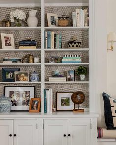 a white bookcase filled with lots of books