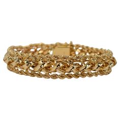 A perfect choice when looking for the bold look of gold but in a modest width. Multi-dimensional, with an interesting braided design, the highly polished 14 karat yellow gold is trimmed with accenting 14 karat yellow gold roping to create this desirable bracelet. At a moderate 1/2 inch width, this substantial gold statement piece is sized to fit most and presents beautifully when worn independently or combined with other pieces in your jewelry wardrobe. Of quality construction, the bracelet is f Luxury Yellow Gold Braided Bracelets For Formal Occasions, Luxury Yellow Gold Braided Bracelets For Women, Gold Bubbles, Retro Bracelet, Jewelry Wardrobe, Braid Designs, Multi Dimensional, Gold Charm Bracelet, Stylish Bracelet